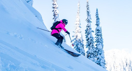 Skier descending steep powder terrain with Great Northern Powder Guides in Montana